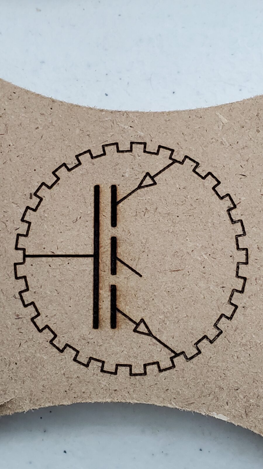 ProAutoTech gear and transistor emblem laser-engraved on an MDF sample