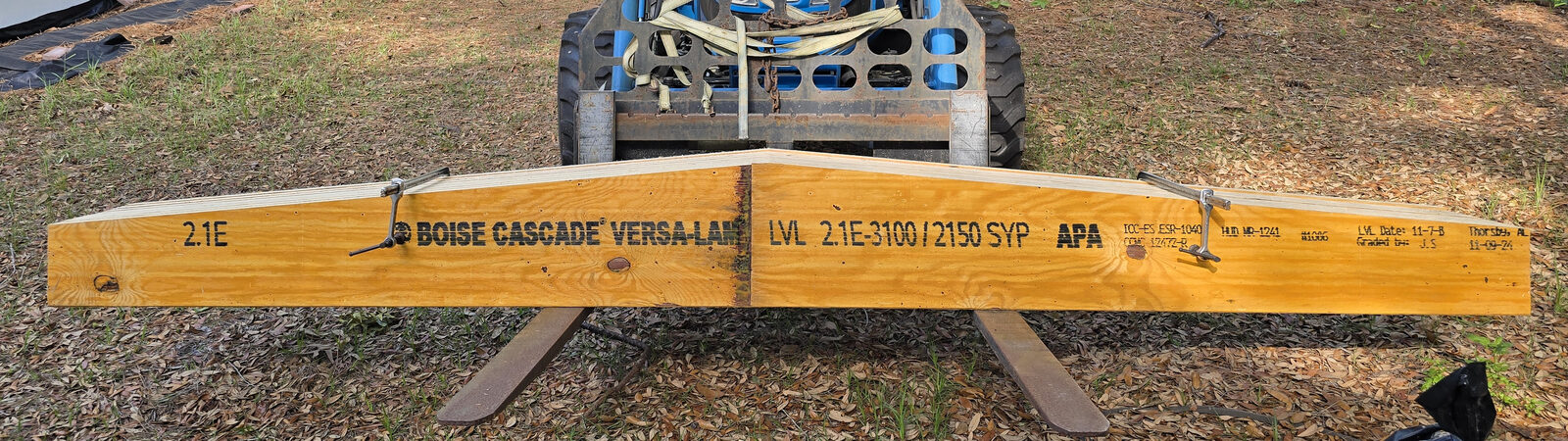Long LVL beam machined to a tapered, peaked profile, carried on tractor forks