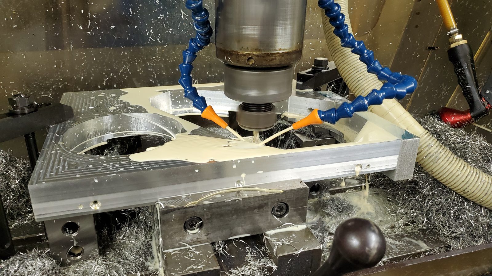 Milling an aluminum part with coolant at Production Automation Technology